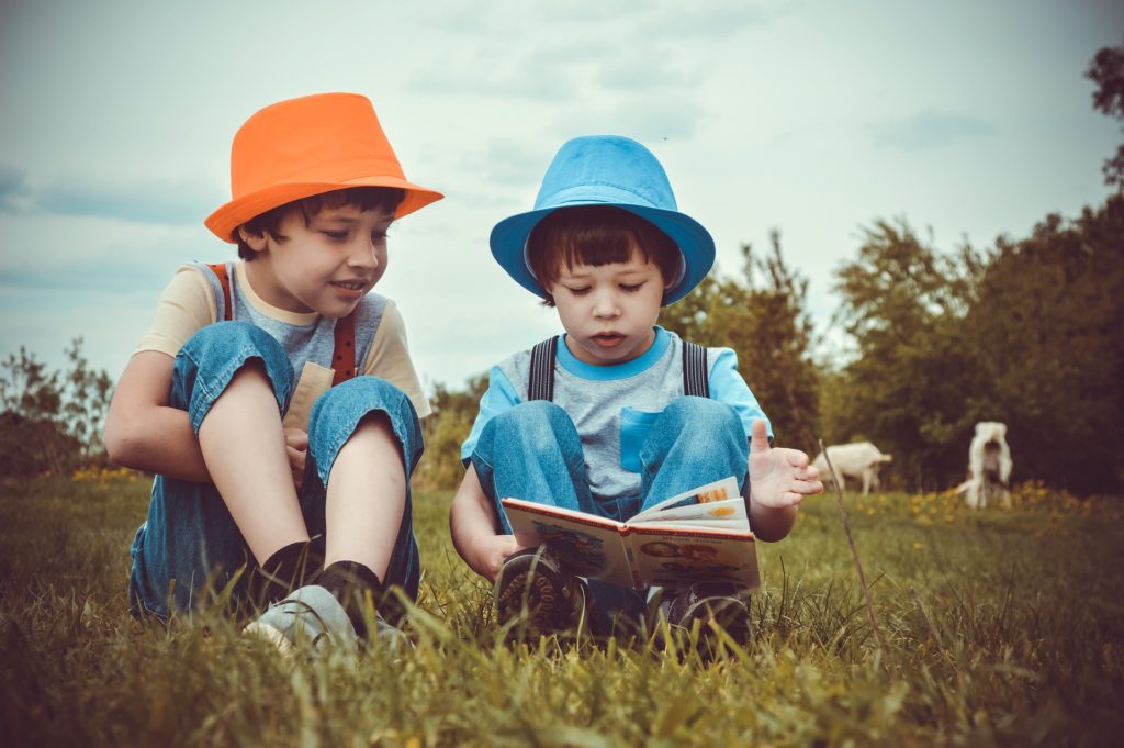 Two children reading a story book