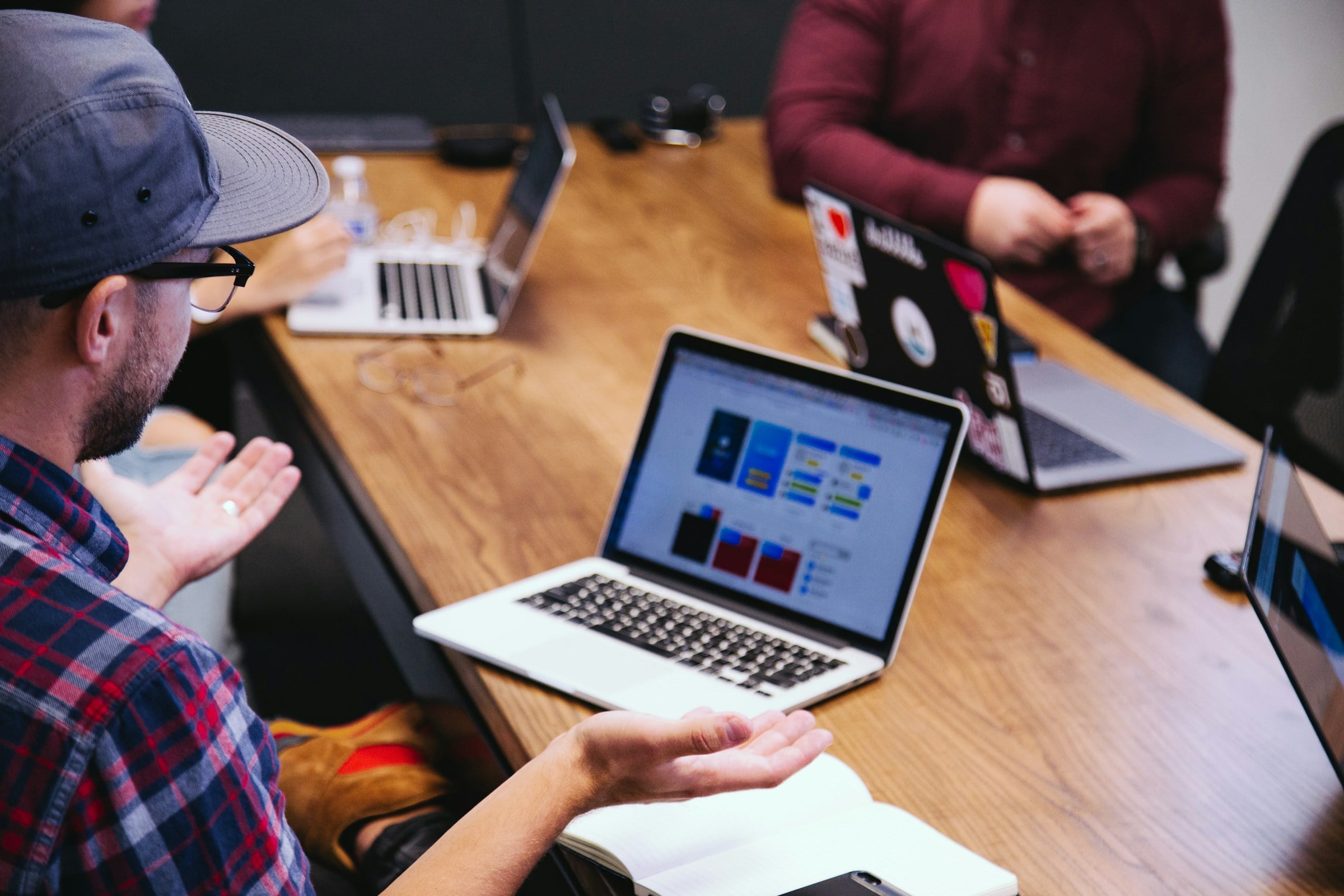 Man sitting at a laptop in a discussion